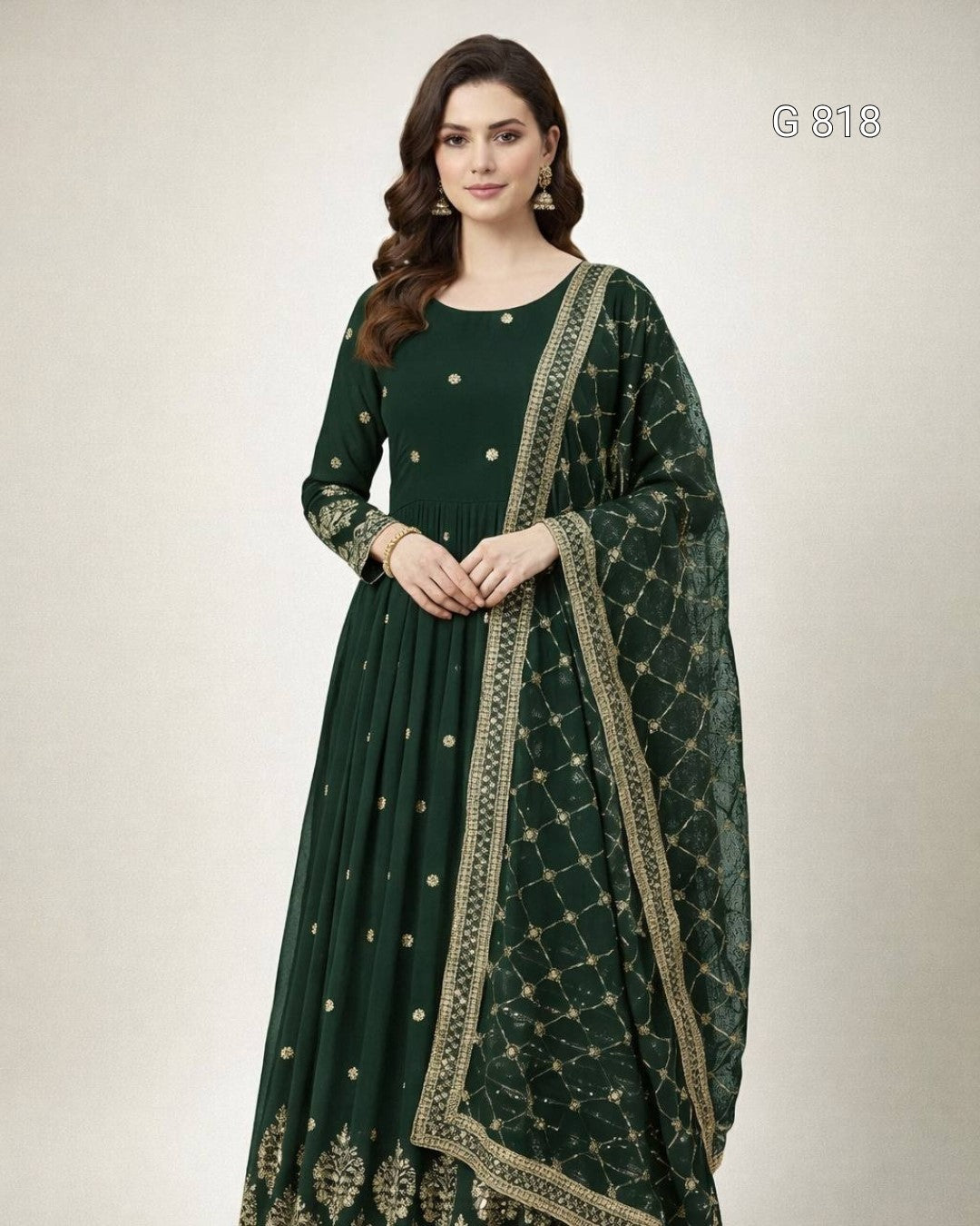 Woman wearing a dark green traditional outfit with gold embroidery on a white background