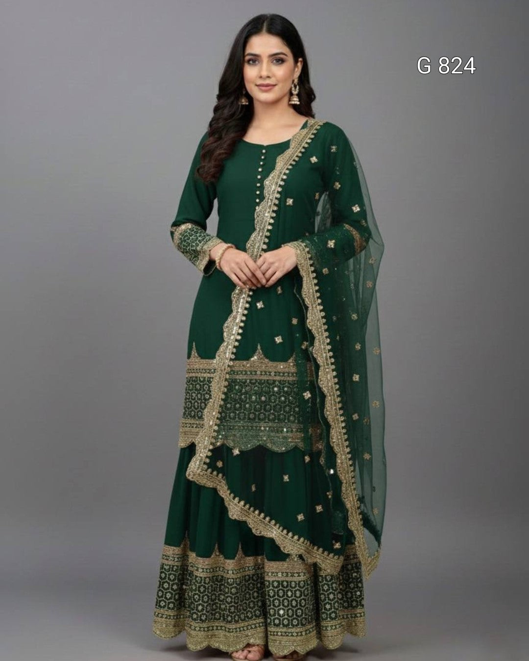 Woman wearing a green traditional outfit with gold embroidery on a gray background