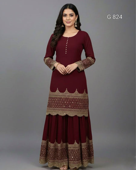Woman wearing a maroon dress with gold patterns on a gray background