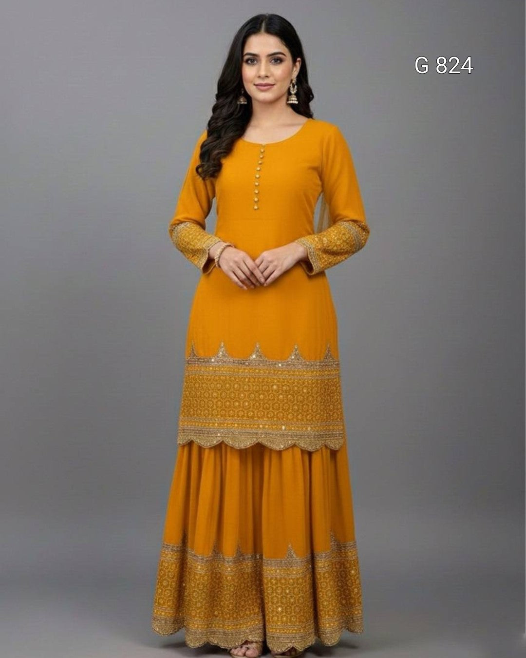 Woman wearing a mustard yellow dress with intricate patterns on a gray background