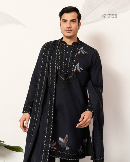 Man wearing a navy blue embroidered kurta with a matching shawl on a white background