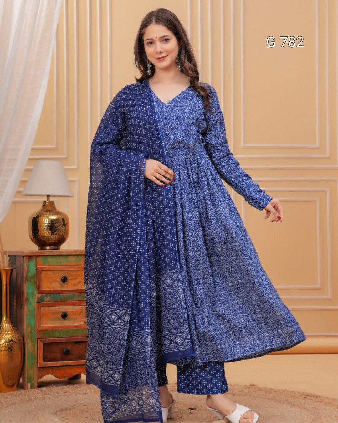 Woman wearing a blue patterned dress in an indoor setting