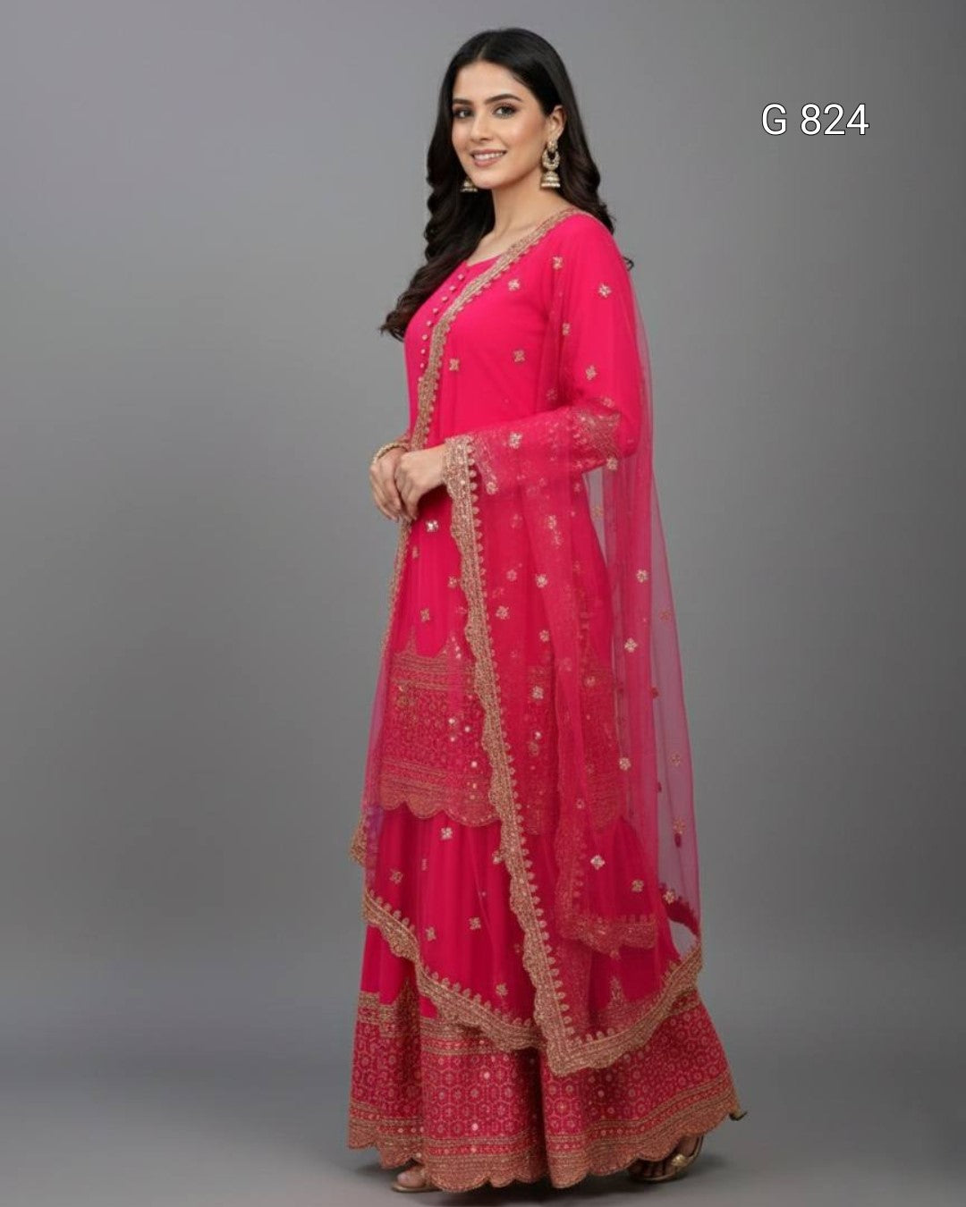 Woman wearing a pink traditional outfit with gold embroidery on a gray background