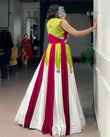 Woman taking a mirror selfie wearing a colorful dress with vertical stripes in a room.