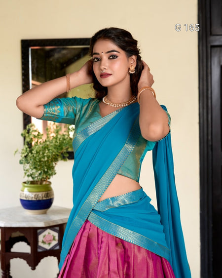 Woman in a blue saree with a pink blouse indoors