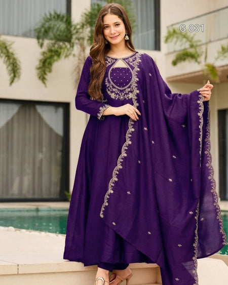 Woman wearing a purple embroidered outfit by a poolside