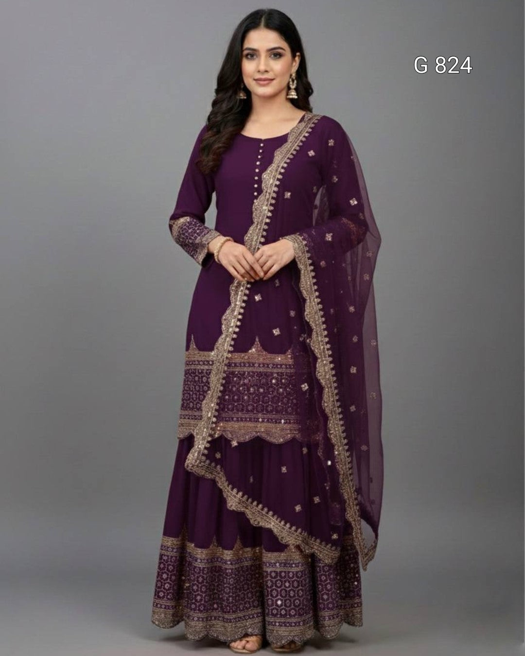 Woman wearing a purple traditional outfit with intricate designs on a gray background