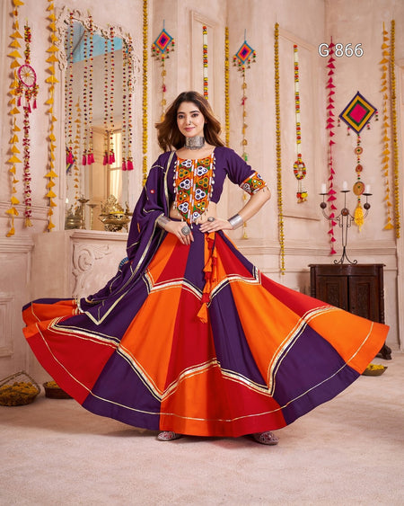 Woman in a colorful traditional outfit with a decorative background