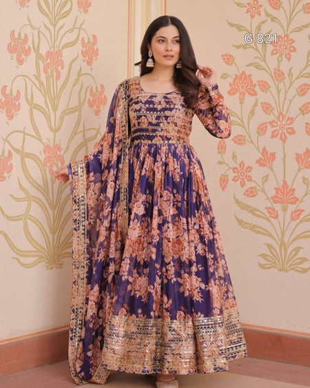 Woman wearing a floral dress with a patterned wall in the background