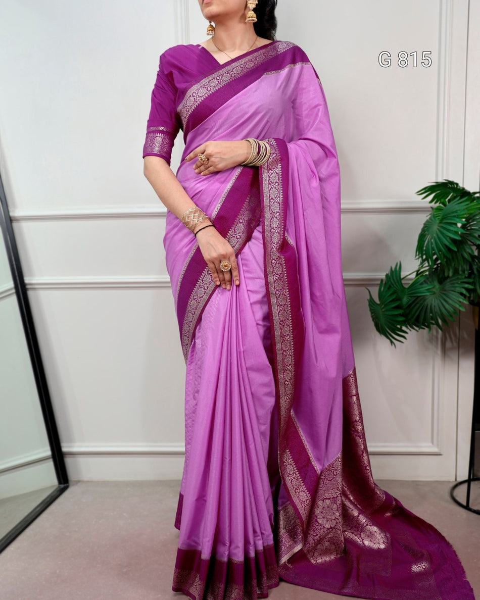 Purple saree with a white border worn by a model against a white wall.