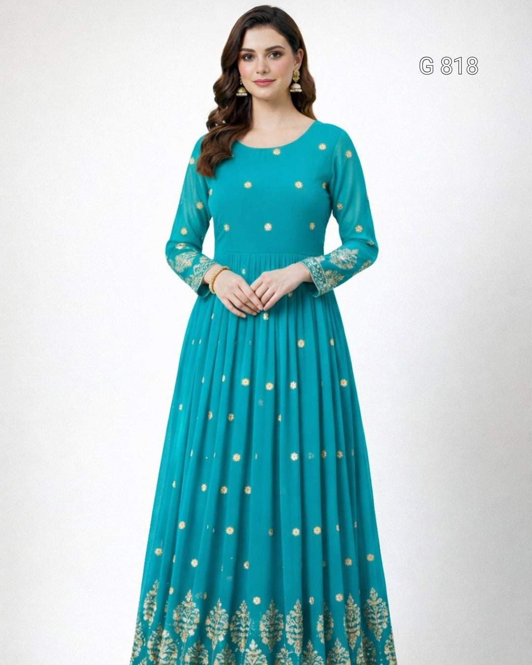 Woman wearing a teal dress with gold patterns on a white background