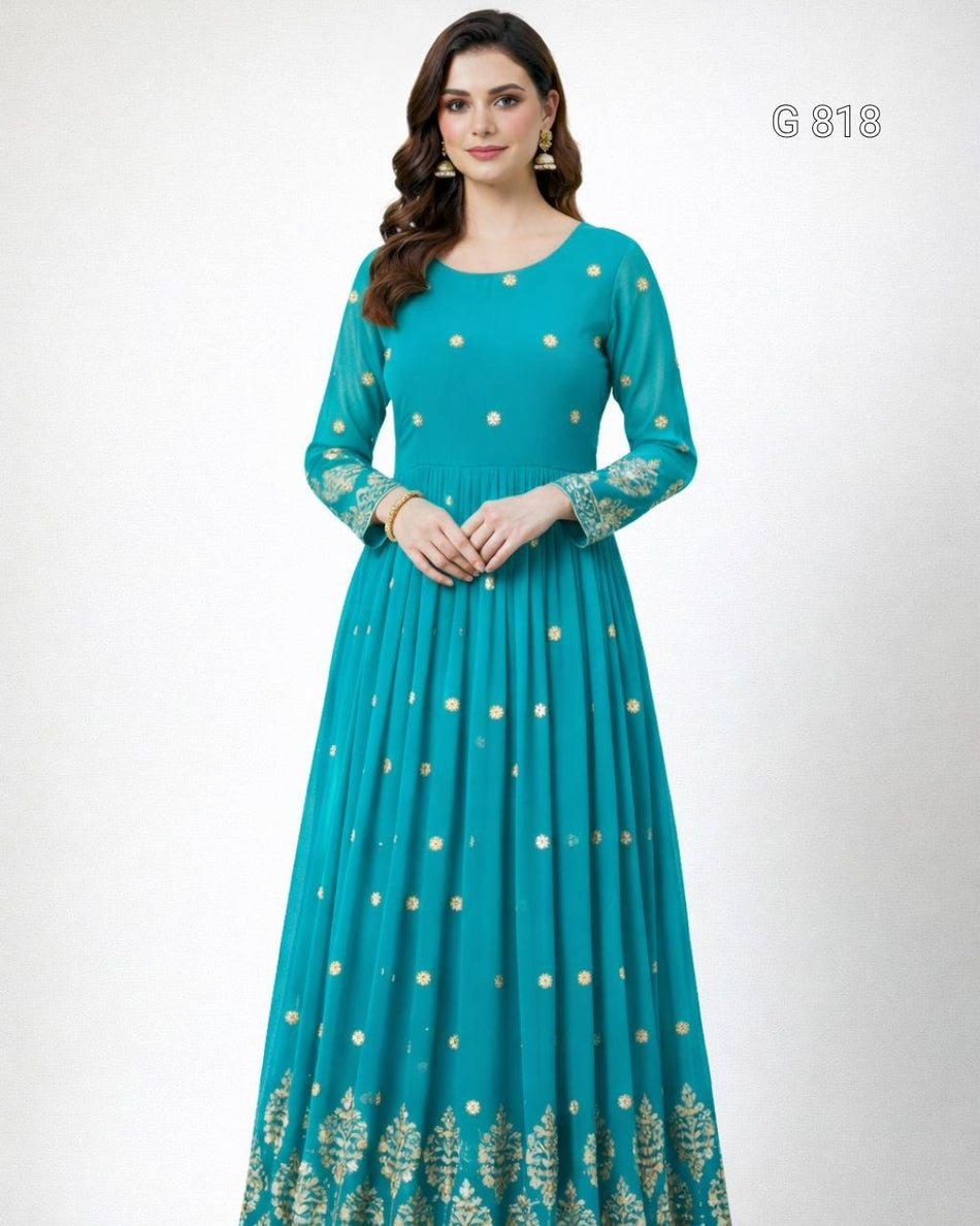 Woman wearing a teal dress with gold patterns on a white background
