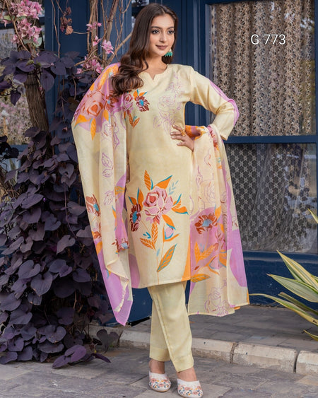 Woman wearing a light-colored traditional outfit with floral patterns, standing outdoors.