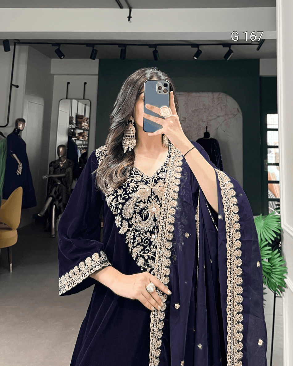 Person wearing a dark blue embroidered outfit in a store setting.