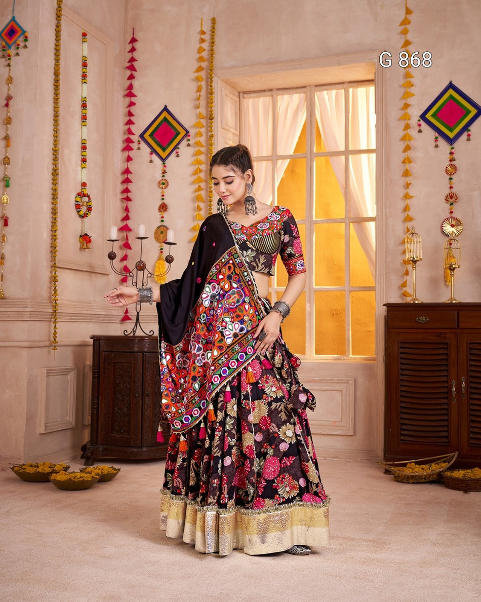 Woman in a colorful traditional outfit standing in a decorated room with hanging decorations.