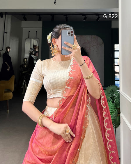 Woman in a pink saree with a white blouse taking a mirror selfie.