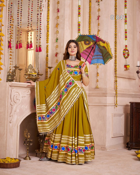 Woman in a traditional outfit holding a colorful umbrella in a decorated room.
