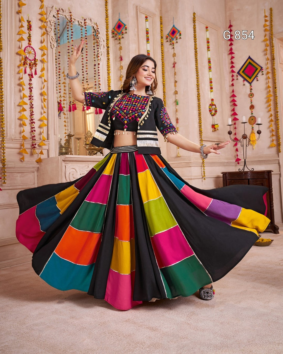 Woman in a colorful traditional outfit with a vibrant skirt in a decorated room.