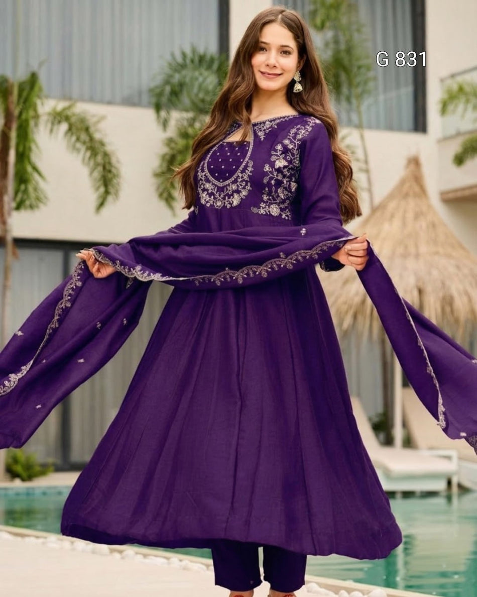 Woman wearing a purple embroidered outfit by a poolside