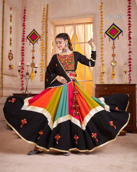 Woman in a colorful traditional outfit with a decorated room background