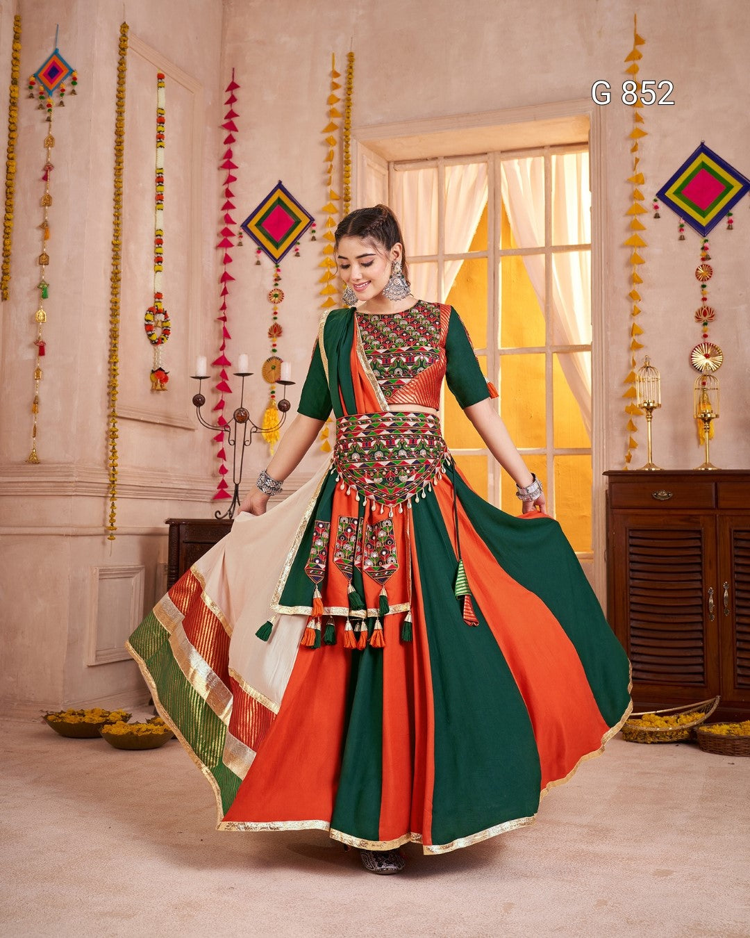 Woman in a traditional outfit with vibrant colors in a decorated room.