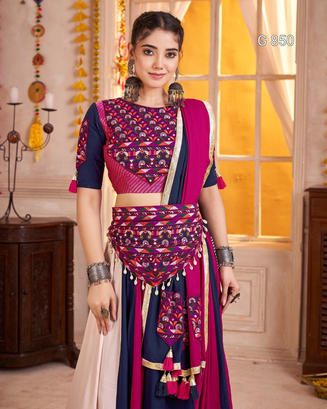 Woman wearing a traditional outfit with a colorful pattern in a decorated room.