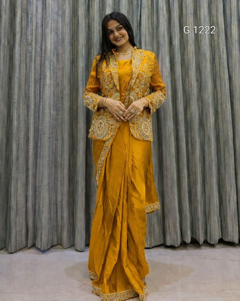 A woman modeling a mustard yellow traditional outfit with an embroidered blazer and matching draped skirt, standing in front of gray curtains. The text 'G 1222' appears in the upper right.