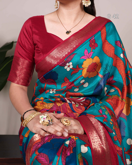 Woman wearing a colorful saree with a floral pattern, holding it in her hands.