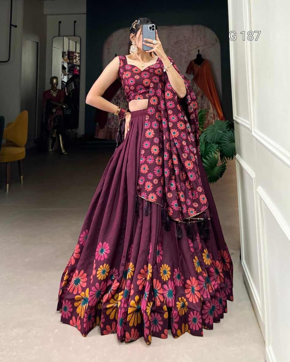 Woman wearing a purple floral traditional outfit in a room.