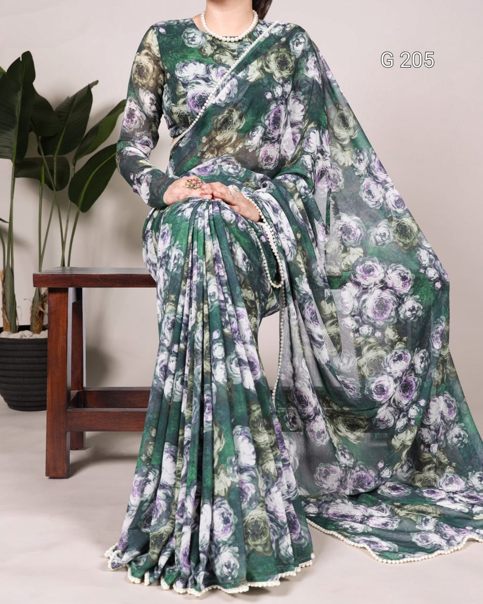 Woman wearing a green floral saree with a white blouse against a neutral background