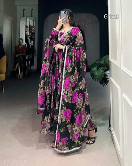 Person wearing a floral dress in a room with a mirror and chair.