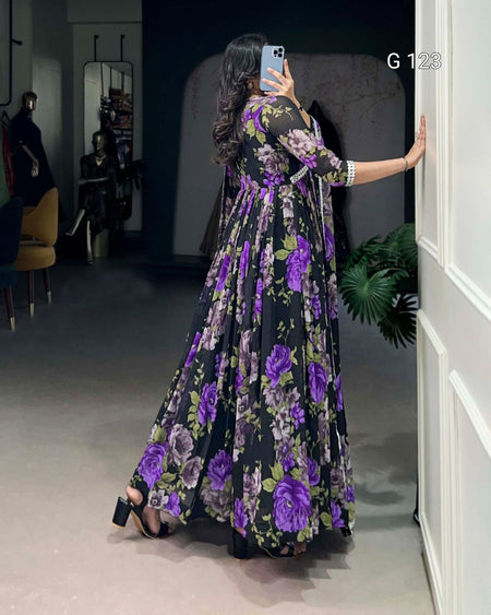 Woman in a floral dress taking a mirror selfie in a room.