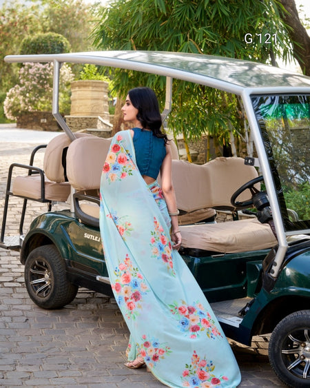 Woman in a floral saree standing next to a golf cart in a park-like setting