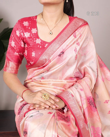 Woman wearing a pink and white floral saree with a subtle background