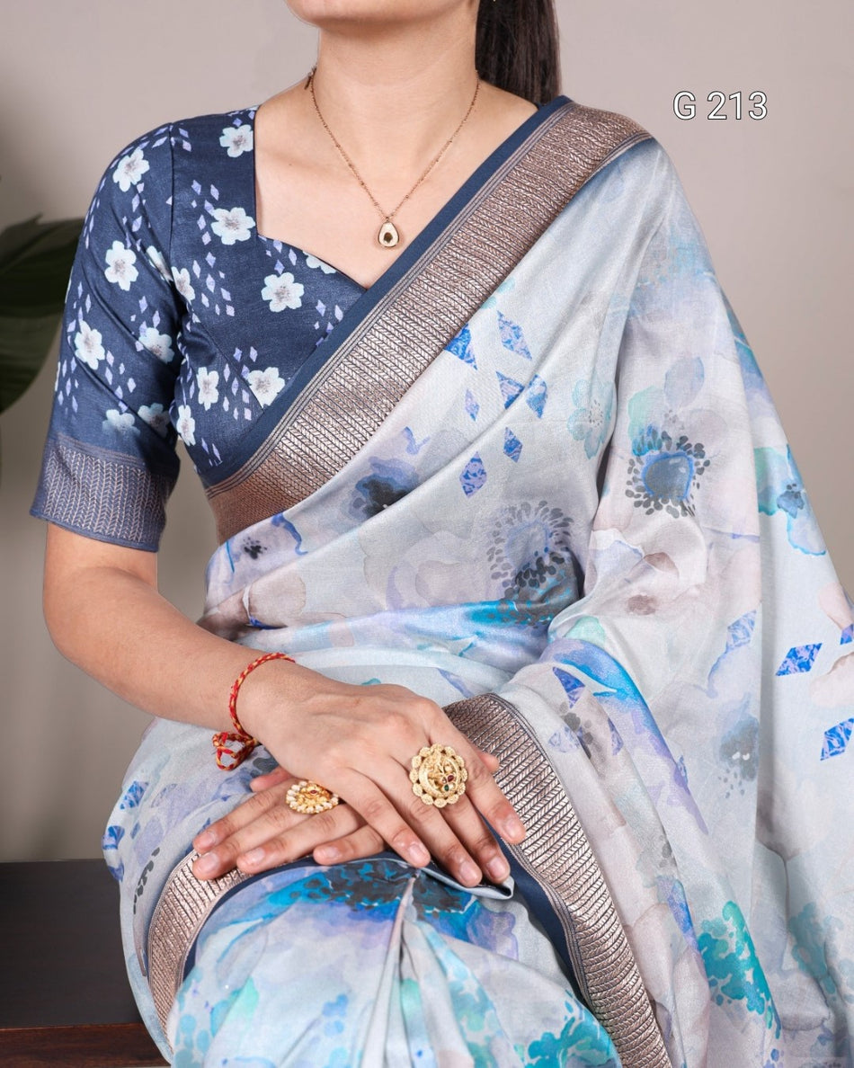 Woman wearing a floral saree with a plain background