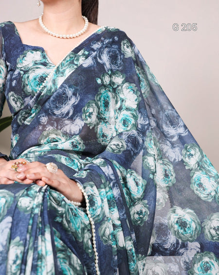 Woman wearing a blue floral saree with a plain background