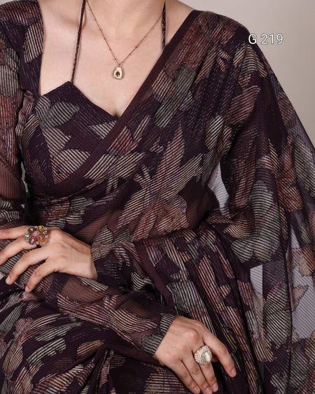 Person wearing a patterned dress with a neutral background
