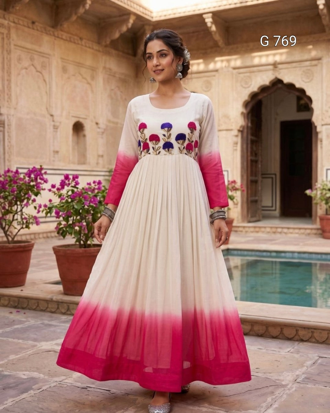 Woman wearing a traditional outfit with floral embroidery in an outdoor setting.