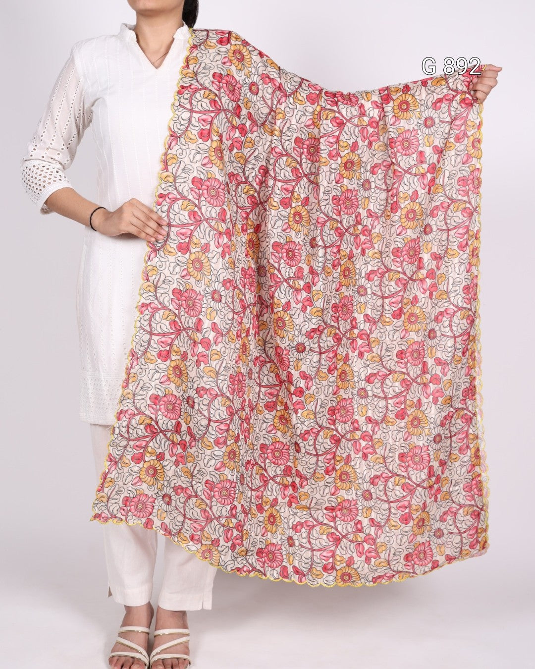 Person holding a floral patterned scarf against a white background