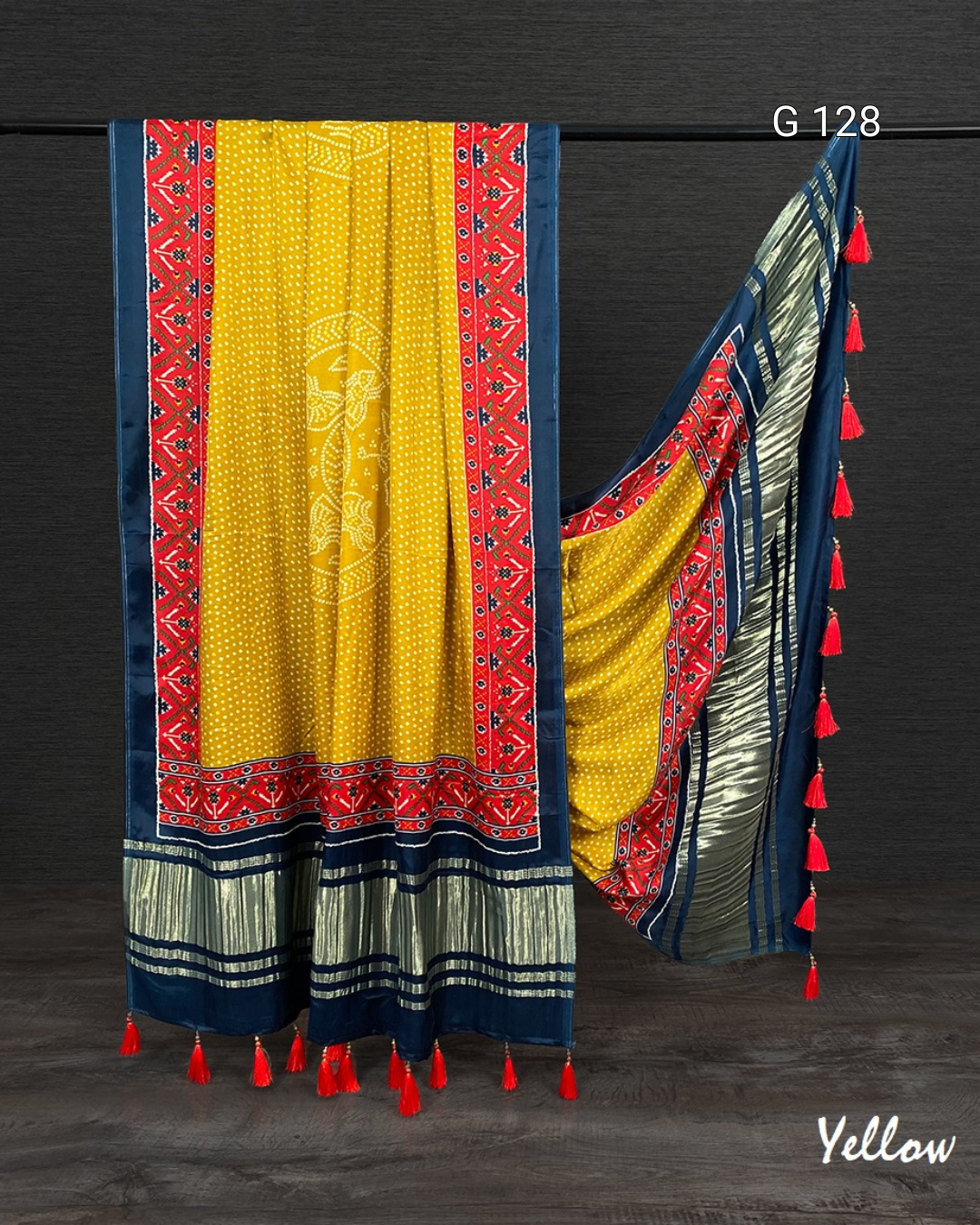 Colorful saree with patterns and tassels on a dark background