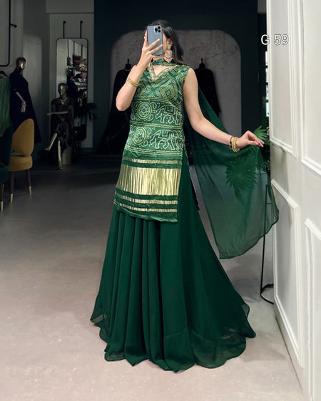Woman wearing a green traditional outfit in a room with mirrors.