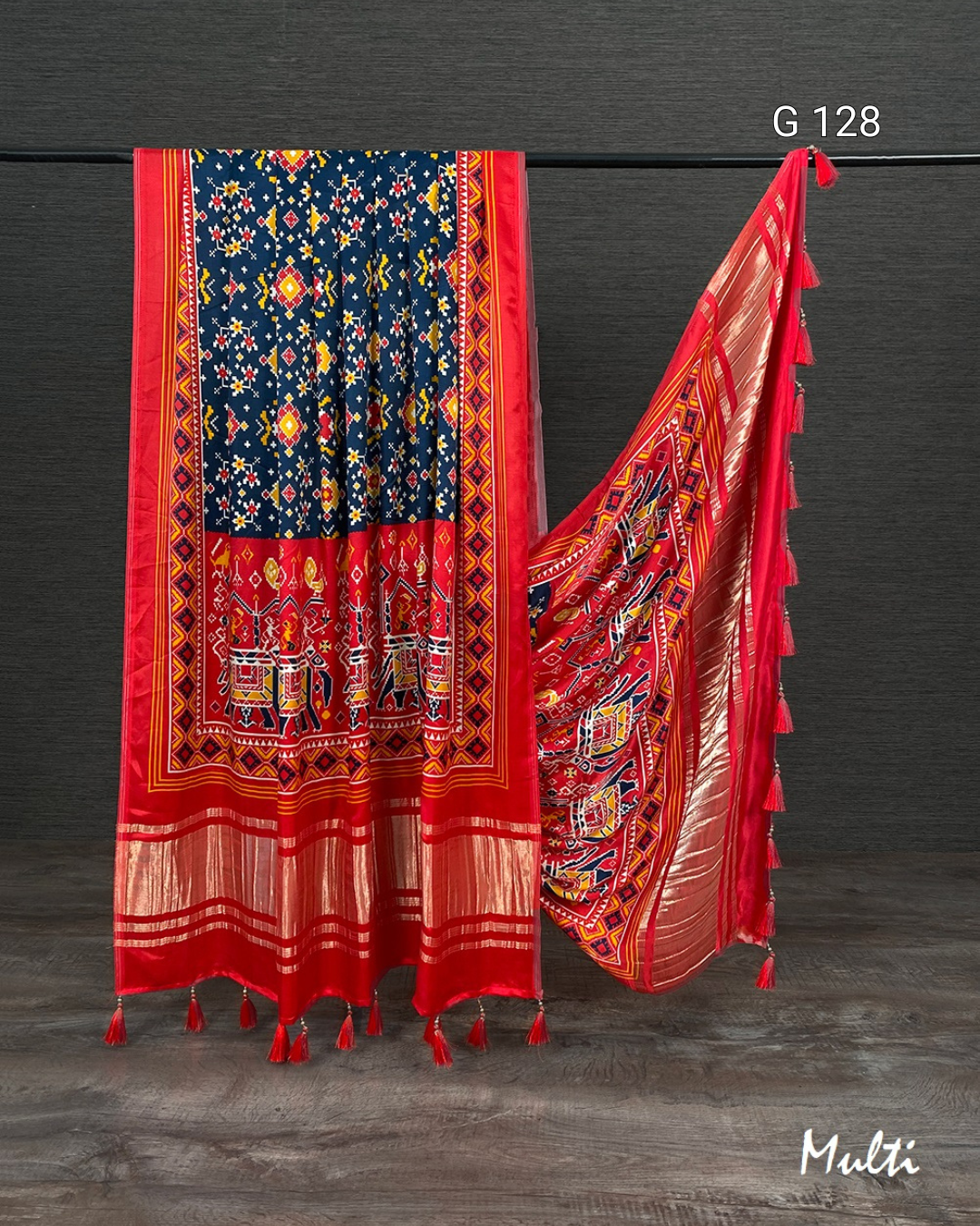 Colorful traditional saree with intricate patterns on a dark background
