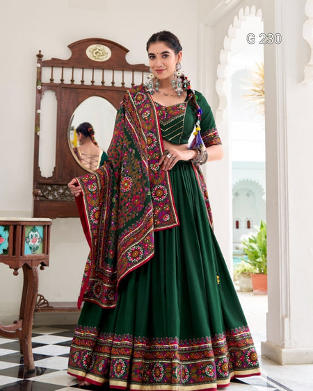 Woman in a green traditional outfit with a colorful shawl in an elegant interior setting