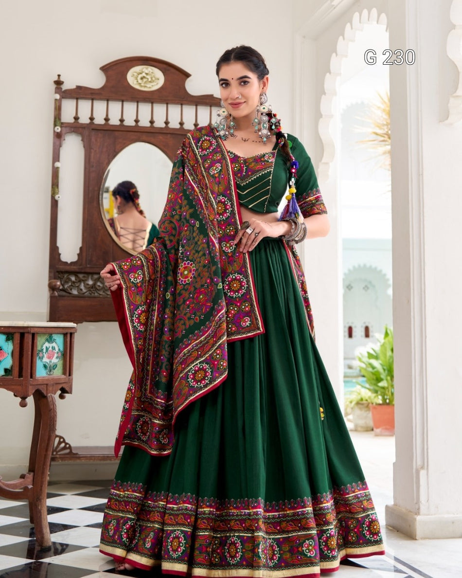 Woman in a green traditional outfit with a colorful shawl in an elegant interior setting