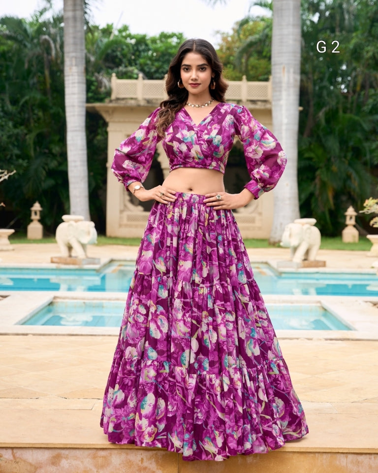 Woman in a purple floral outfit standing by a pool with greenery in the background