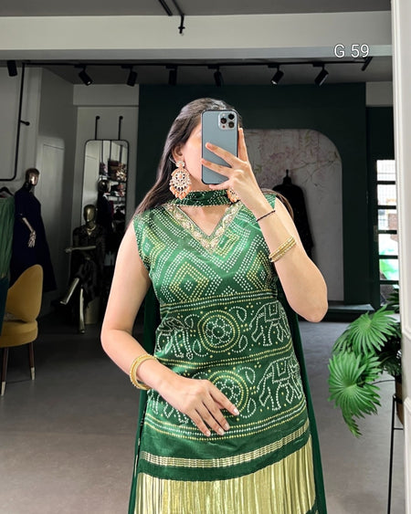 Woman wearing a green and gold traditional outfit in an indoor setting.