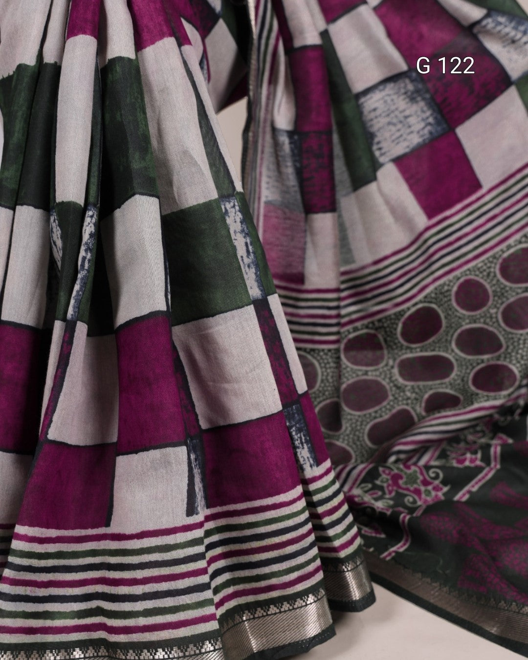 Patterned fabric with purple, green, and white colors on a plain background