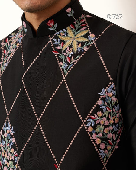 Black embroidered shirt with floral patterns on a white background
