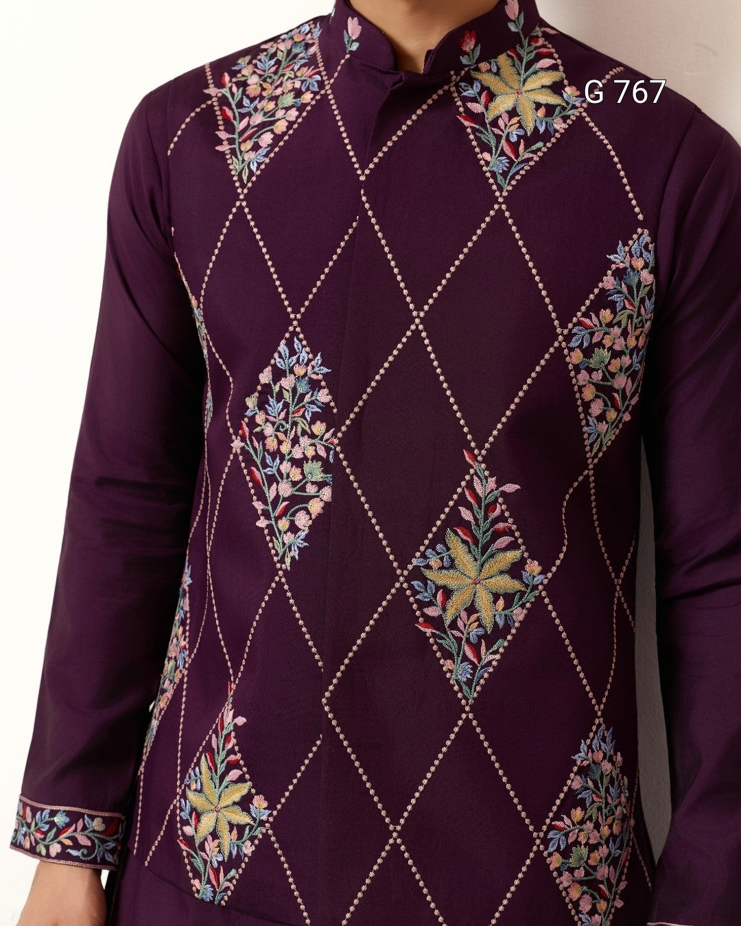Purple embroidered shirt with geometric patterns on a plain background