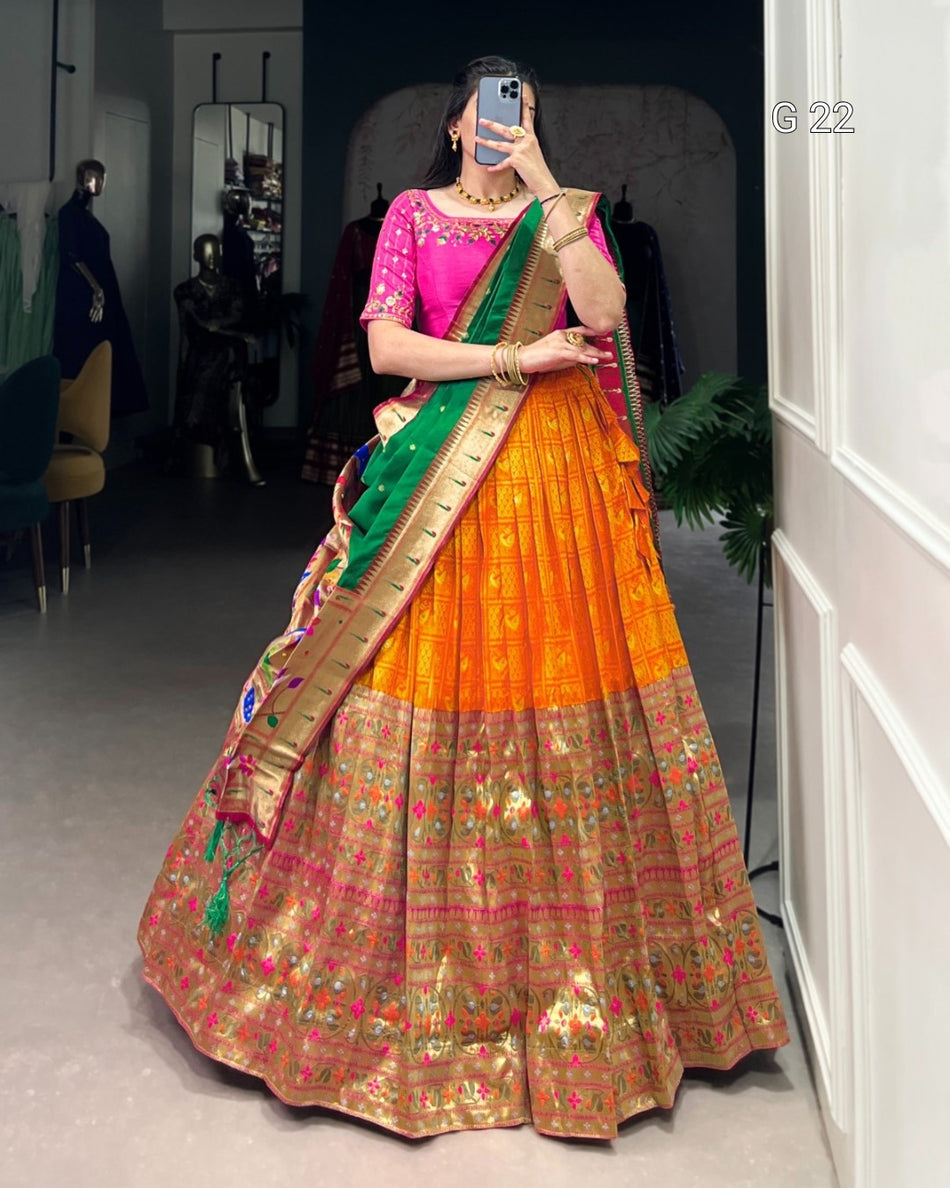 Person wearing a colorful saree with a traditional blouse in a room setting.